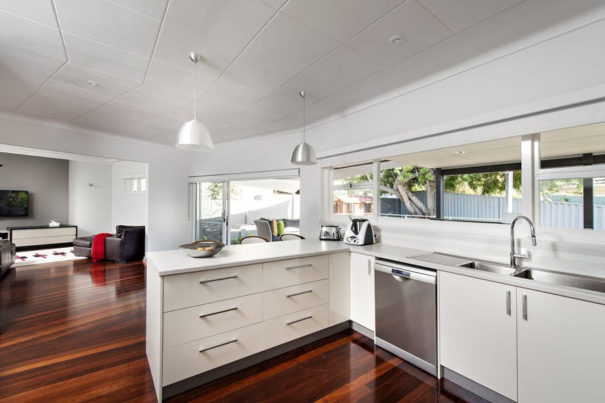 The strategic choice of lighting over the kitchen bench makes it more practical for food preparation.